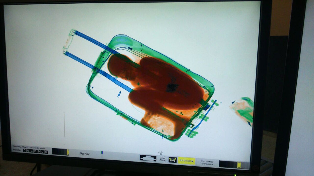 0572e5d2-APTOPIX Spain Boy in Suitcase