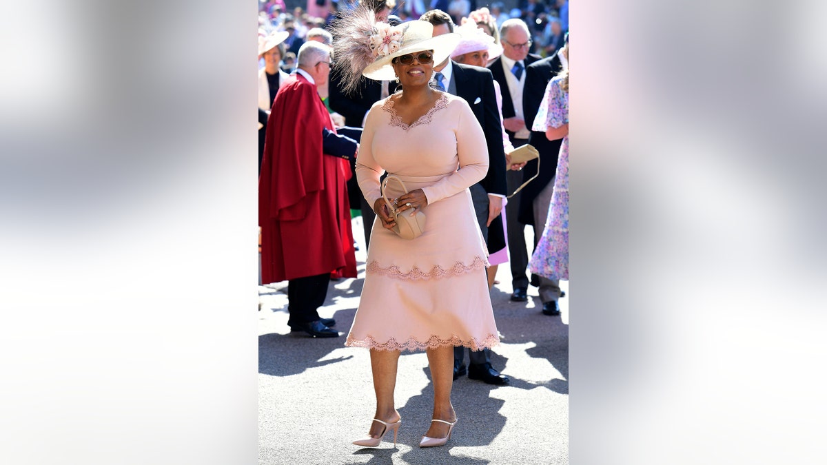 Oprah Winfrey smiles as she arrives at St George's Chapel at Windsor Castle the wedding ceremony of Prince Harry and Meghan Markle at St. George's Chapel in Windsor Castle in Windsor, near London, England, Saturday, May 19, 2018. (Ian West/pool photo via AP)