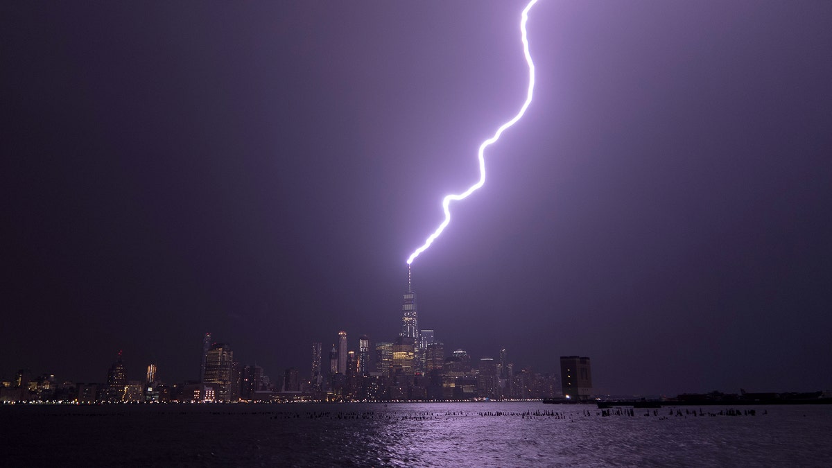 HOBOKEN, NJ - AUGUST 22: Lightning lights up the sky over lower Manhattan as a bolt strikes One World Trade Center in New York City on August 22, 2017 as seen from Hoboken, New Jersey. (FOX News/Gary Hershorn