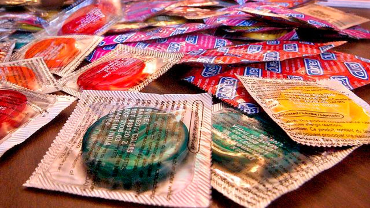 An assortment of condoms is offered for free to visitors of the Statehouse during a World AIDS Day ceremony inside the rotunda at the Illinois State Capitol in Springfield, Ill., Wednesday, Dec. 1, 2004. Some Illinois health workers have said they were disappointed that Illinois Gov. Rod Blagojevich has ordered the Illinois Department of Public Health not to buy any more condoms in bright colors or flavors like orange and cherry. (AP Photo/Seth Perlman)
