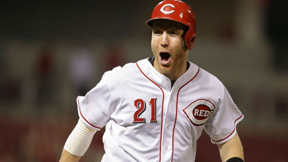 Cincinnati Reds' Todd Frazier reacts after hitting a grand slam in the thirteenth inning of a baseball game against the Detroit Tigers, Thursday, June 18, 2015, in Cincinnati. The Reds won 8-4. (AP Photo/John Minchillo)