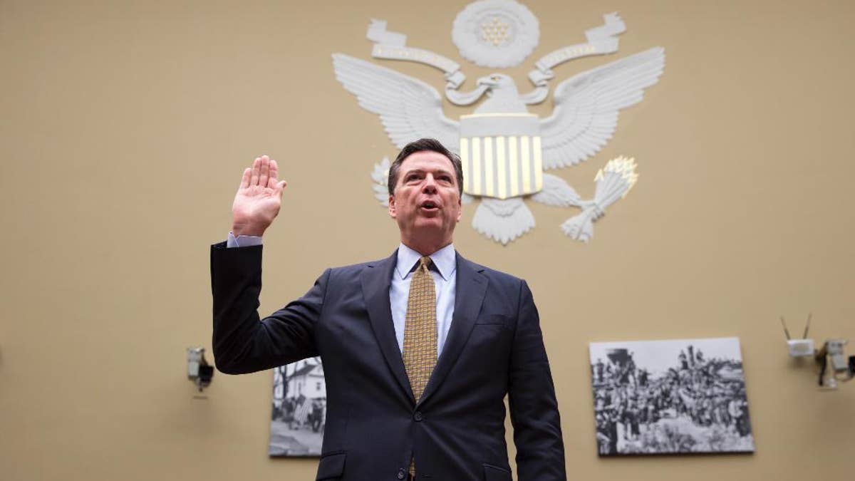 FBI Director James Comey is sworn in on Capitol Hill in Washington, Thursday, July 7, 2016, prior to testifying before the House House Oversight and Government Reform Committee hearing to explain his agency's recommendation to not prosecute  Democratic presidential candidate Hillary Clinton over her private email setup. (AP Photo/J. Scott Applewhite)