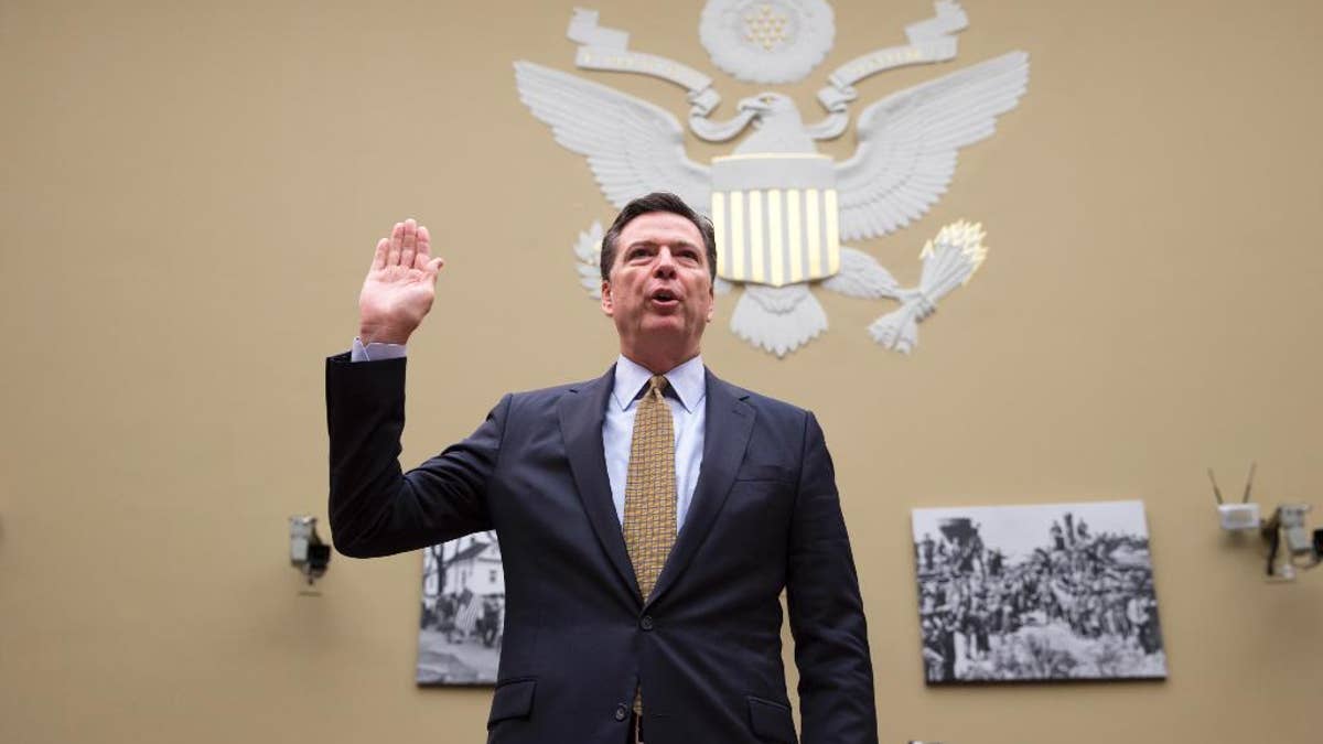 FBI Director James Comey is sworn in on Capitol Hill in Washington, Thursday, July 7, 2016, prior to testifying before the House House Oversight and Government Reform Committee hearing to explain his agency's recommendation to not prosecute  Democratic presidential candidate Hillary Clinton over her private email setup. (AP Photo/J. Scott Applewhite)