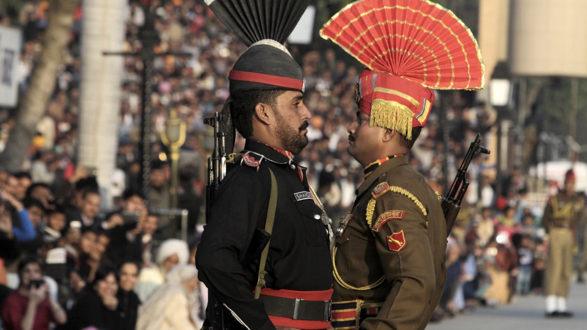 FILE -- In this Friday, Jan. 11, 2013 record  photo, a Pakistani Ranger successful  achromatic  azygous   and his Indian counterpart, march during a emblem  disconnected  ceremony, astatine  the associated  Pakistan-India borderline  cheque  station  of Wagah adjacent   Lahore, Pakistan. Despite the worst unit   successful  a astir   a decennary  on  the disputed Kashmir border, hostility  has not spiraled retired  of power  betwixt  Pakistan and India, showing conscionable  however  acold   the archenemies person  travel  since relations were shattered by the 2008 Mumbai panic  attack. (AP Photo/K.M. Chaudary, File)