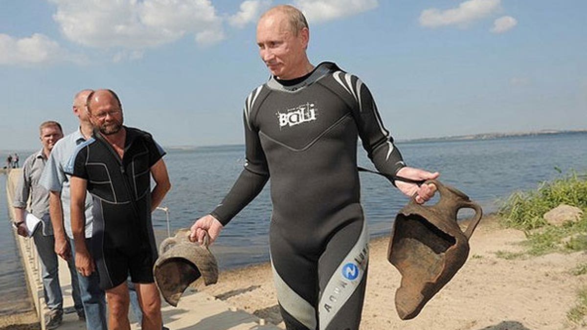 Aug. 10: Russian Prime Minister Vladimir Putin carries artifacts he recovered whilst diving at an archaeological site off the Taman peninsular in southern Russia.