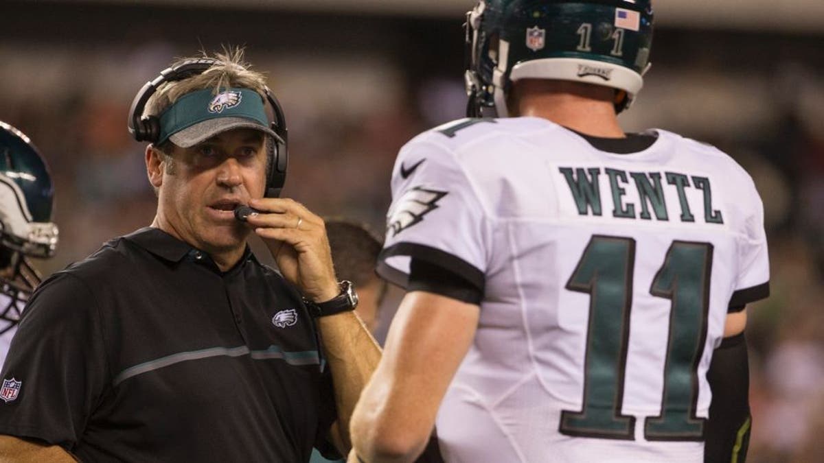 PHILADELPHIA, PA - AUGUST 11: Head coach Doug Pederson of the Philadelphia Eagles talks to Carson Wentz #11 during a timeout in the game against the Tampa Bay Buccaneers at Lincoln Financial Field on August 11, 2016 in Philadelphia, Pennsylvania. The Eagles defeated the Buccaneers 17-9. (Photo by Mitchell Leff/Getty Images)