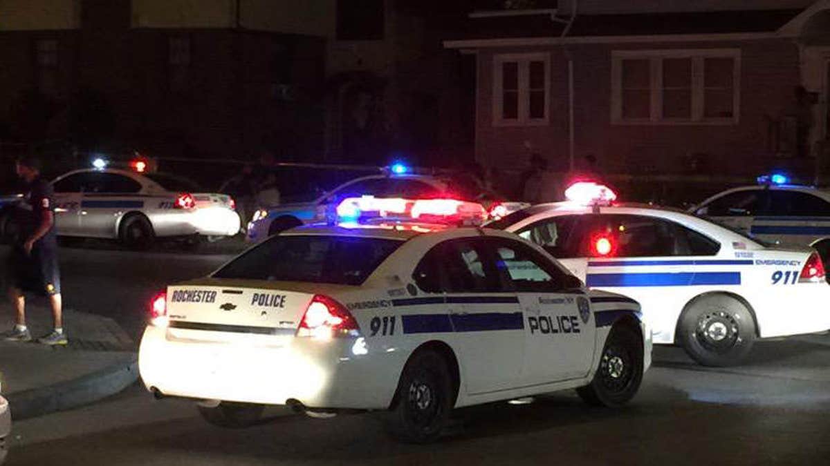 Aug. 19, 2015: In this photo provided by WHEC-TV, police vehicles block off the street after official said a fatal shooting occurred in Rochester, N.Y.