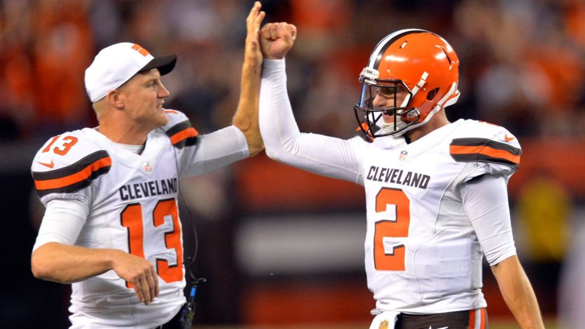 Cleveland Browns quarterback Josh McCown (13) congratulates Johnny Manziel (2) after Manziel threw a 21-yard touchdown pass to Shane Wynn during the fourth quarter of an NFL preseason football game against the Buffalo Bills, Thursday, Aug. 20, 2015, in Cleveland. (AP Photo/David Richard)