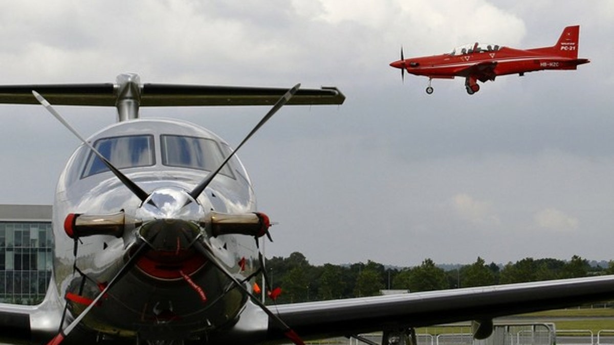 Pilatus DC-21 (R) comes into land over a Pilatus PC-12.