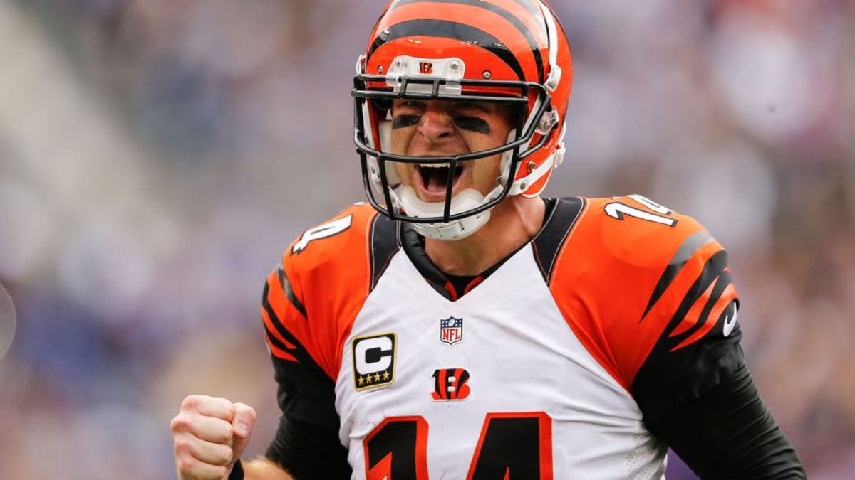 Cincinnati Bengals quarterback Andy Dalton (14) celebrates wide receiver A.J. Green's touchdown during the second half of an NFL football game against the Baltimore Ravens in Baltimore, Sunday, Sept. 27, 2015. The Bengals defeated the Ravens 28-24. (AP Photo/Patrick Semansky)