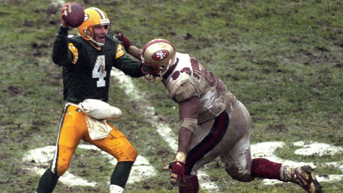 GREEN BAY, WI - JANUARY 4, 1997: Brett Favre #4 of the Green Bay Packers looks to pass during the NFL Divisional Playoff Game against the San Francisco 49ers on January 4, 1997 in Green Bay, Wisconsin. (Photo by Ronald C. Modra/Sports Imagery/Getty Images)