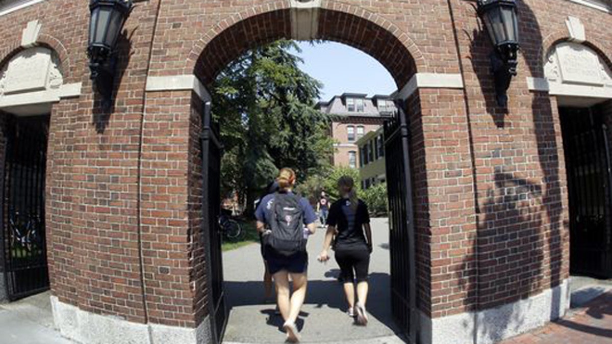 Students walking on Harvard University's campus in Cambridge, Massachusetts.
