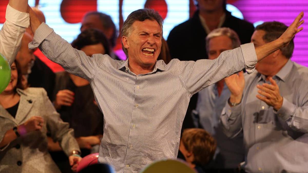 Surrounded by supporters, the current Mayor of Buenos Aires and presidential candidate Mauricio Macri celebrates at the end of mayoral elections in Buenos Aires, Argentina, Sunday, July 5, 2015. Buenos Aires will have a runoff election that would have the current Cabinet Chief of Buenos Aires and mayoral candidate Horacio Rodriguez Larreta competing against Martín Lousteau, candidate of the ECO coalition. (AP Photo/Daniel Jayo)