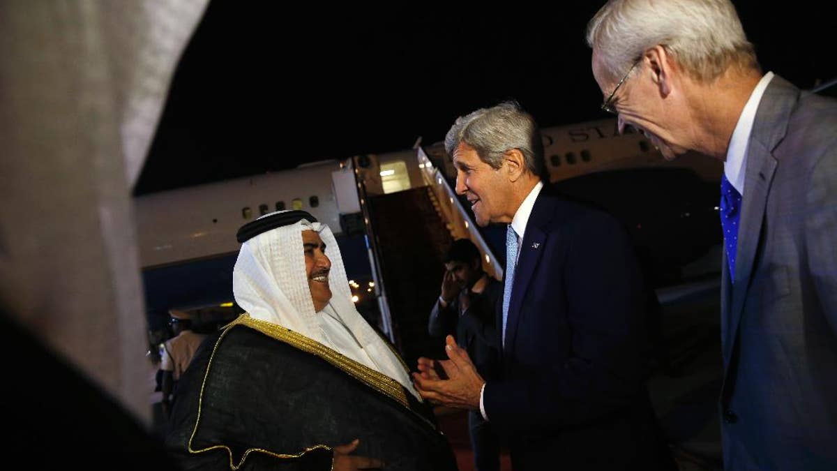 Bahrain's Foreign Minister Khalid bin Ahmed Al Khalifa, left, and U.S. Ambassador to Bahrain William Roebuck, right, greets U.S. Secretary of State John Kerry, second right, as he arrives aboard his plane at Bahrain International Airport in Manama, Bahrain April 6, 2016. (Jonathan Ernst/Pool via AP)