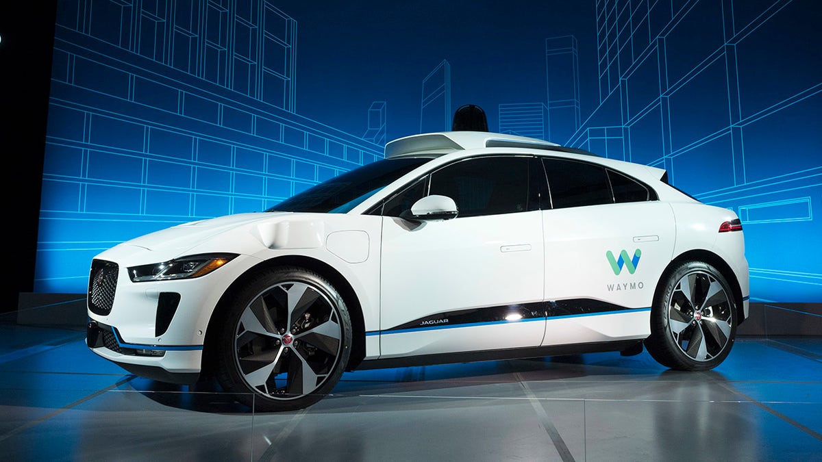 The Jaguar I-Pace vehicle is introduced Tuesday, March 27, 2018, in New York. Self-driving car pioneer Waymo will buy up to 20,000 of the electric vehicles from Jaguar Land Rover to help realize its vision for a robotic ride-hailing service. The commitment announced Tuesday marks another step in Waymo's evolution from a secret project started in Google nine years ago to a spin-off that's gearing up for an audacious attempt to reshape the transportation business. (AP Photo/Mark Lennihan)