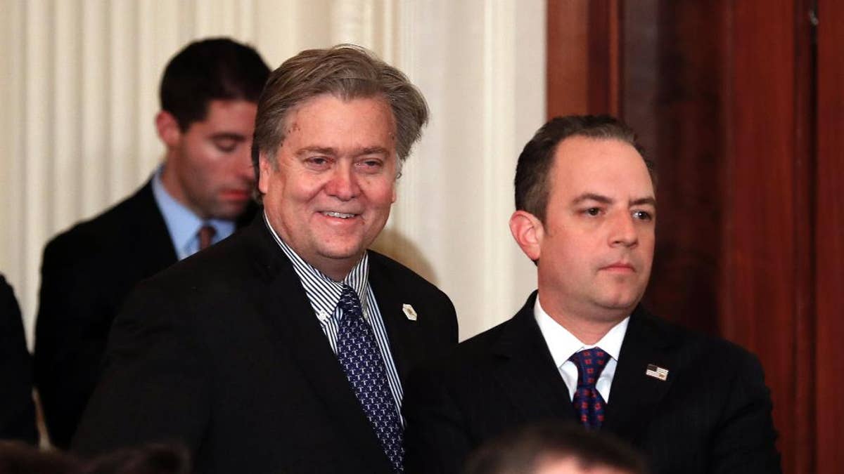 In this Jan. 31, 2017, photo, Steve Bannon, chief White House strategist to President Donald Trump, left, and White House Chief of Staff Reince Priebus stand in the East Room of the White House in Washington before President Donald Trump arrived to announce Judge Neil Gorsuch as his nominee for the Supreme Court. The Trump administration is playing down the significance of a National Security Council restructuring. But the president is treading new ground in making Bannon a regular at NSC meetings. (AP Photo/Carolyn Kaster)