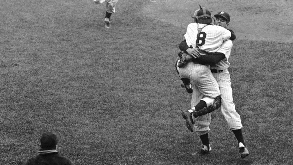 NEW YORK - OCTOBER 8: Pitcher Don Larsen (r), of the New York Yankees, wraps his arms around catcher Yogi Berra #8 after the final pitch of Game 5 of the 1956 World Series against the Brooklyn Dodgers at Yankee Stadium in New York. Larsen pitched the first perfect game in World Series history as the Yankees defeated Sal Maglie and the Dodgers, 2-0. (Photo by: Diamond Images/Getty Images)