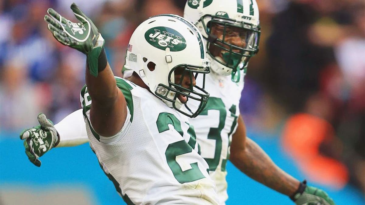 LONDON, ENGLAND - OCTOBER 04: Darrelle Revis #24 of the New York Jets celebrates his interception with Antonio Cromartie #31 of the New York Jets during the game against Miami Dolphins at Wembley Stadium on October 4, 2015 in London, England. (Photo by Stephen Pond/Getty Images)