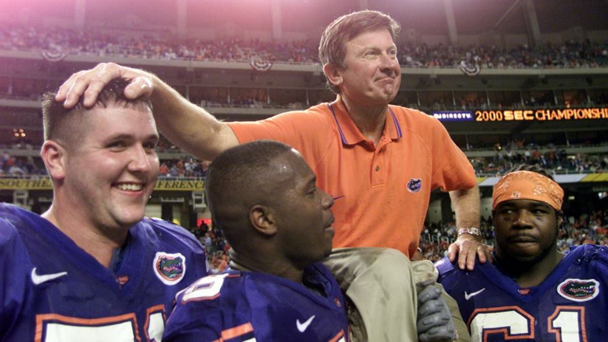 2 Dec 2000: Head coach Steve Spurrier of the Florida Gators is carried off the field by players following the Gators'' 28-6 victory over Auburn to win the Southeastern Conference (SEC) Championship at the Georgia Dome in Atlanta, Georgia. DIGITAL IMAGE Mandatory Credit: Jamie Squire/ALLSPORT