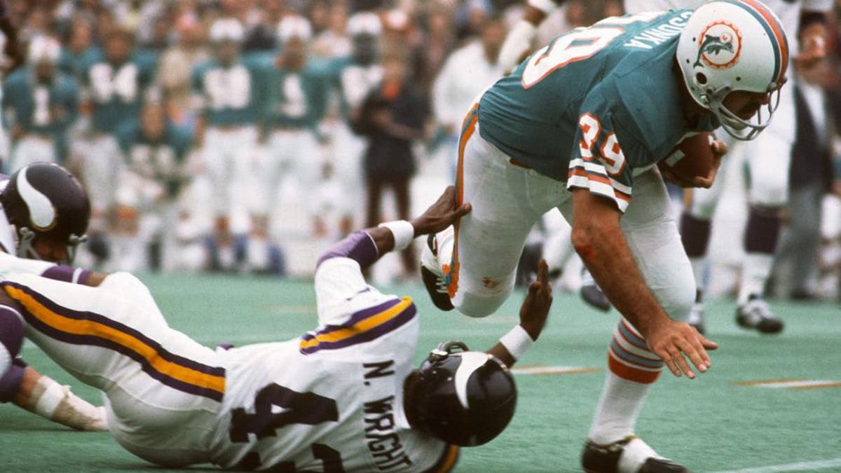 HOUSTON, TX - JANUARY 13: Larry Csonka #39 of the Miami Dolphins runs through the tackle of Nate Wright #43 of the Minnesota Vikings during Super Bowl VIII at Rice Stadium January 13, 1974 in Houston, Texas. The Dolphins won the Super Bowl 24-7. (Photo by Focus on Sport/Getty Images)