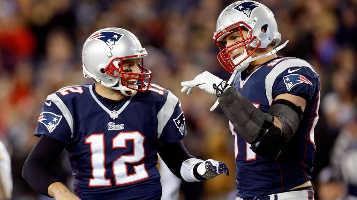 Nov 3, 2013; Foxborough, MA, USA; New England Patriots quarterback Tom Brady (12) congratulates tight end Rob Gronkowski (87) on scoring a touchdown during the second quarter against the Pittsburgh Steelers at Gillette Stadium. Mandatory Credit: Greg M. Cooper-USA TODAY Sports