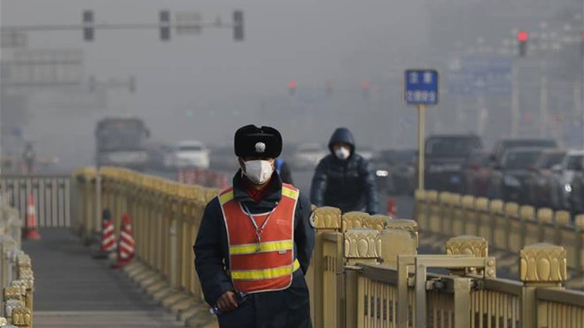 Chinese police in heavy smog wearing mask