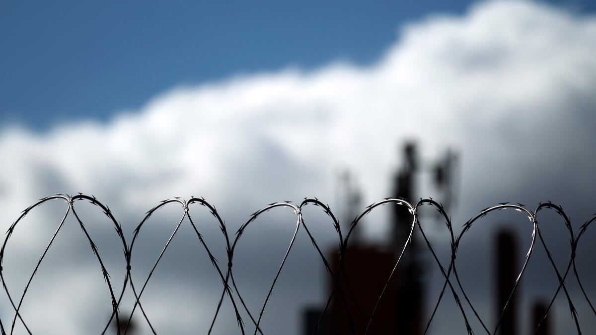 In this Monday, Jan. 31, 2011 photo, razor wire sits atop a border fence as a building in the Mexican border city of Tijuana sits behind, as seen from San Diego. After a dropoff during the recession, illegal immigrants seeking to sneak across the U.S. border may be ready to move again, according to a new study released Tuesday. (AP Photo/Gregory Bull)