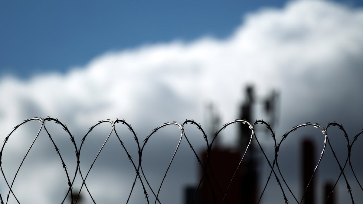 In this Monday, Jan. 31, 2011 photo, razor wire sits atop a border fence as a building in the Mexican border city of Tijuana sits behind, as seen from San Diego. After a dropoff during the recession, illegal immigrants seeking to sneak across the U.S. border may be ready to move again, according to a new study released Tuesday. (AP Photo/Gregory Bull)