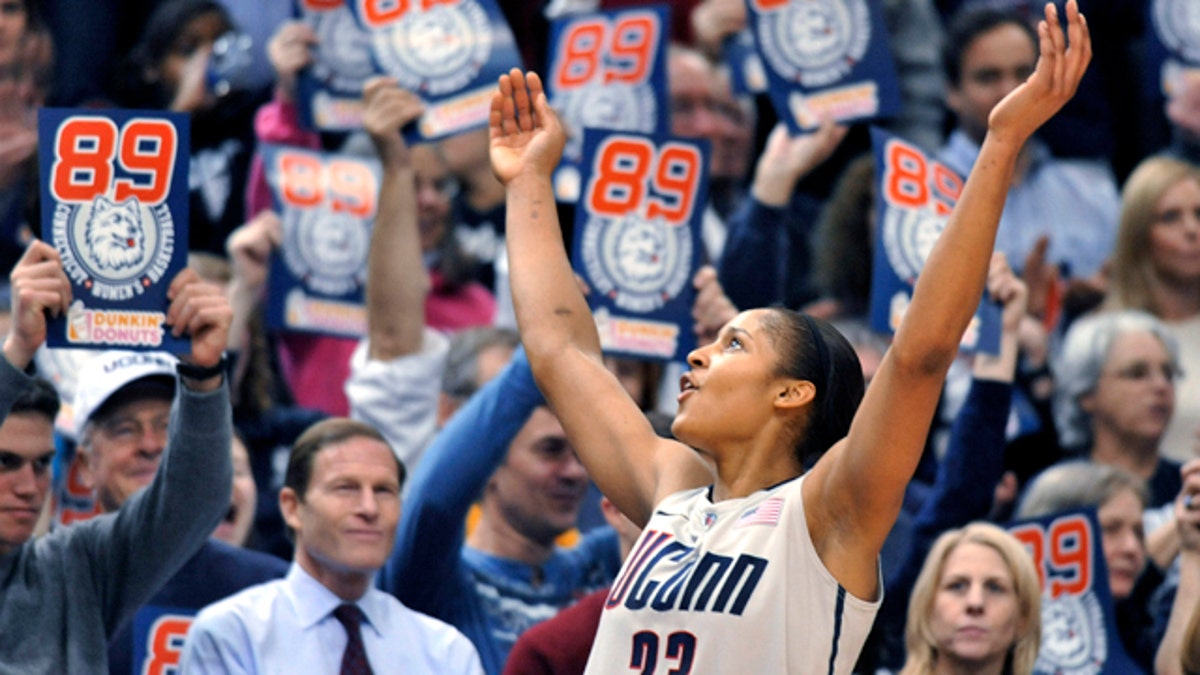 Connecticut forward Maya Moore celebrates near the end of an NCAA college basketball game against Florida State in Hartford, Conn., Tuesday, Dec. 21, 2010. Connecticut beat Florida State 93-62 to to set an NCAA record for consecutive wins, at 89. (AP Photo/Jessica Hill)