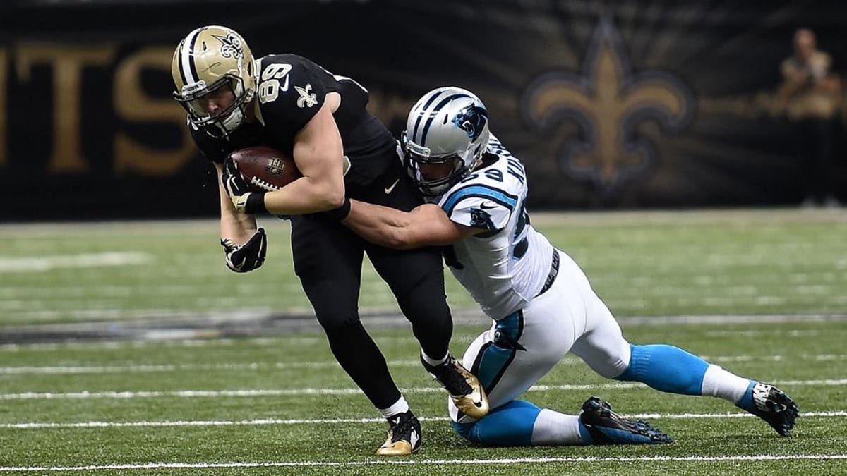 NEW ORLEANS, LA - DECEMBER 06: Josh Hill #89 of the New Orleans Saints is brought down by Luke Kuechly #59 of the Carolina Panthers during a game at the Mercedes-Benz Superdome on December 6, 2015 in New Orleans, Louisiana. Carolina defeated New Orleans 41-38. (Photo by Stacy Revere/Getty Images)