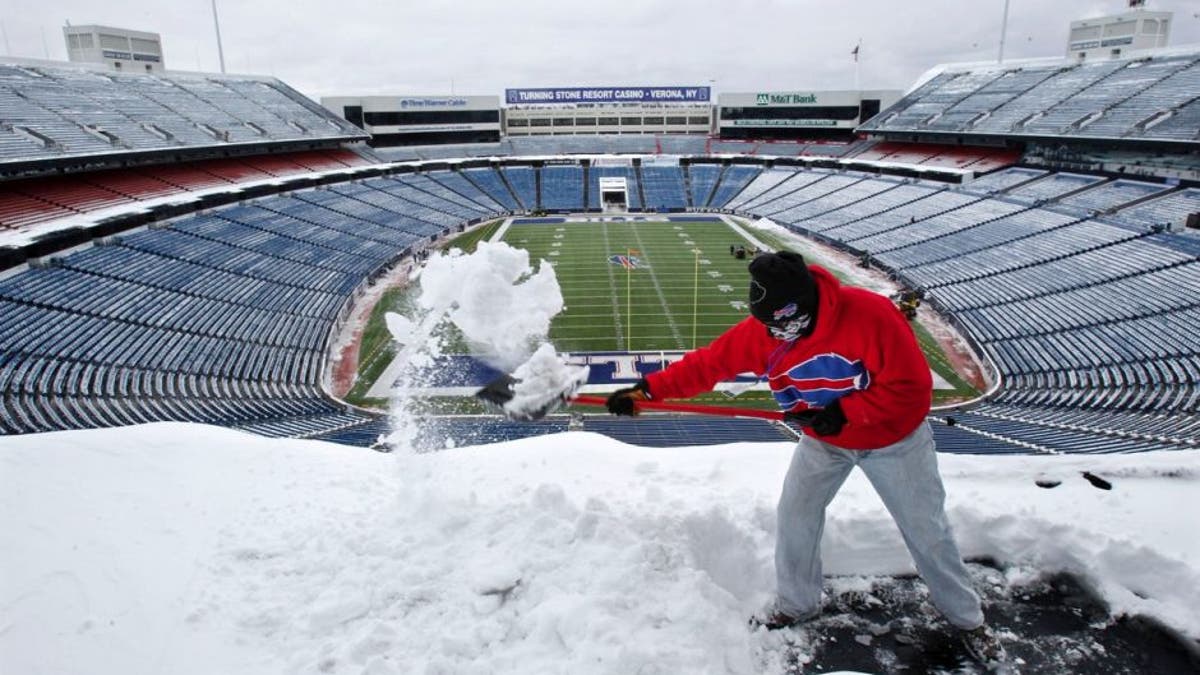 Buffalo Bills fans work hard and play hard while shovelling snow at stadium