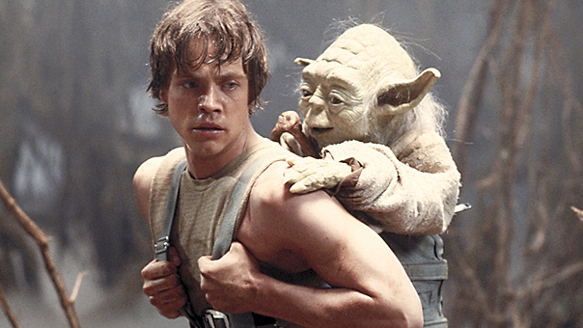 This 1980 publicity image originally released by Lucasfilm Ltd. shows Mark Hamill as Luke Skywalker and the character Yoda in a scene from 'Star Wars Episode V: The Empire Strikes Back.'