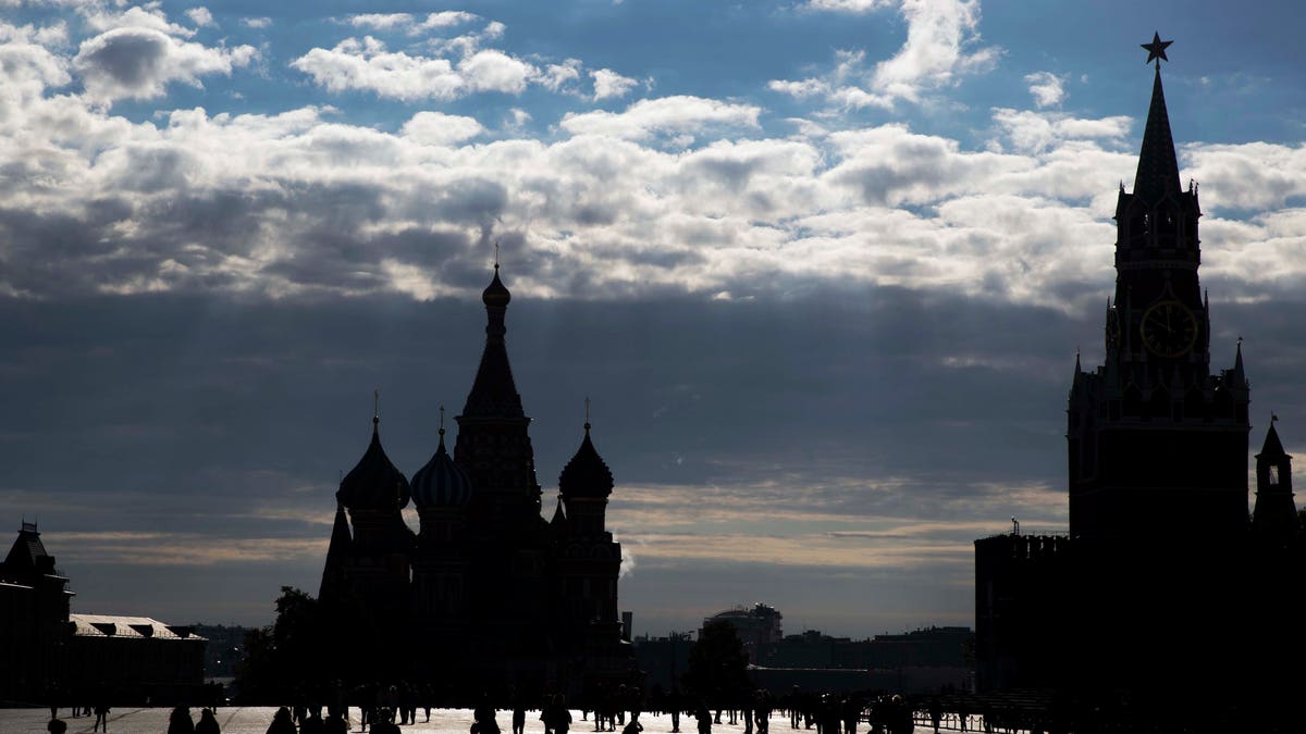 People walk at Red Square in Moscow, Russia, Monday, Sept. 26, 2016. The Red Square is considered the main square of the capital and has held outdoor markets, festivals, and parades. (AP Photo/Pavel Golovkin)