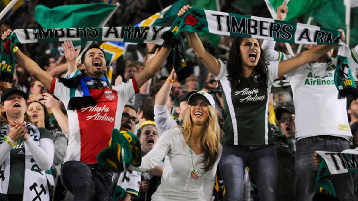 FILE - In this Sunday, Oct. 13, 2013, file photo, Portland Timbers' fans celebrate the win against Seattle in an MLS Soccer game in Portland, Ore. Legend has it that Portland laid claim to the title 