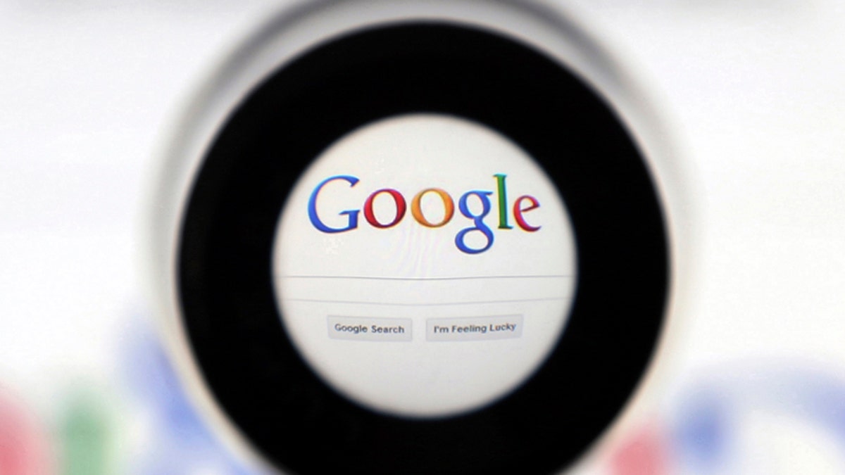 A Google search page is seen through a magnifying glass in this photo illustration taken in Brussels May 30, 2014. Google has taken the first steps to meet a European ruling that citizens can have objectionable links removed from Internet search results, a ruling that pleased privacy campaigners but raised fears that the right can be abused to hide negative information.   REUTERS/Francois Lenoir (BELGIUM - Tags: SCIENCE TECHNOLOGY POLITICS) - RTR3RK8U