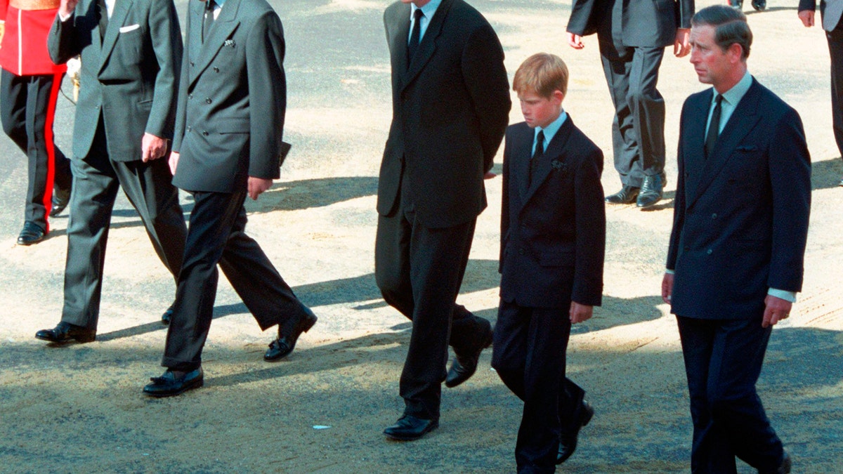 FILE - In this Saturday Sept. 6, 1997 file photo, from left Prince Philip, Prince William, Earl Spencer, Prince Harry and Prince Charles follow the coffin of Diana, Princess of Wales along Horse Guards Parade toward Westminster Abbey, London. Long dismissed as a party boy, Prince Harry has transformed himself in the public eye and enjoys widespread popularity as he prepares to marry Meghan Markle on May 19, 2018. Harry has become a forceful advocate for veterans and won admiration by speaking openly about his struggle with the pain caused by the early death of his mother, Princess Diana. (AP Photo/David Brauchli, file)
