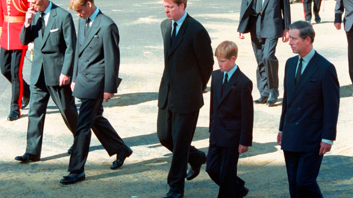 FILE - In this Saturday Sept. 6, 1997 file photo, from left Prince Philip, Prince William, Earl Spencer, Prince Harry and Prince Charles follow the coffin of Diana, Princess of Wales along Horse Guards Parade toward Westminster Abbey, London. Long dismissed as a party boy, Prince Harry has transformed himself in the public eye and enjoys widespread popularity as he prepares to marry Meghan Markle on May 19, 2018. Harry has become a forceful advocate for veterans and won admiration by speaking openly about his struggle with the pain caused by the early death of his mother, Princess Diana. (AP Photo/David Brauchli, file)