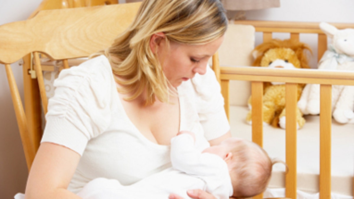17774ad8-Mother Breastfeeding Baby In Nursery