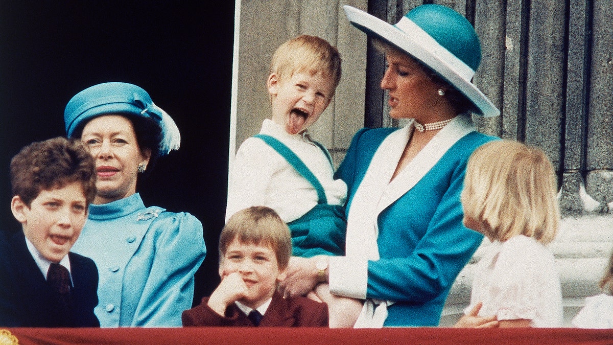 FILE - In this June 11, 1988 file photo, Britain's Prince Harry sticks out his tongue for the cameras on the balcony of Buckingham Palace in London. Long dismissed as a party boy, Prince Harry has transformed himself in the public eye and enjoys widespread popularity as he prepares to marry Meghan Markle on May 19, 2018. Harry has become a forceful advocate for veterans and won admiration by speaking openly about his struggle with the pain caused by the early death of his mother, Princess Diana. (AP Photo/Steve Holland)