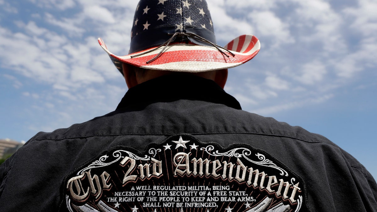 A man wears a patriotic-themed cowboy hat during a pro gun-rights rally at the state capitol, Saturday, April 14, 2018, in Austin, Texas. Gun rights supporters rallied across the United States to counter a recent wave of student-led protests against gun violence. (AP Photo/Eric Gay)