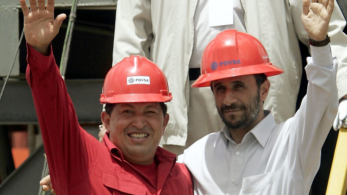FILE - In this Sept. 18, 2006 file photo, Venezuela's President Hugo Chavez, left, and Iran's President Mahmoud Ahmadinejad wave to the press after inaugurating an oil drill in San Tome, Venezuela.  Venezuela's Vice President Nicolas Maduro announced on Tuesday, March 5, 2013 that Chavez has died. Chavez, 58, was first diagnosed with cancer in June 2011. (AP Photo/Fernando Llano, File)