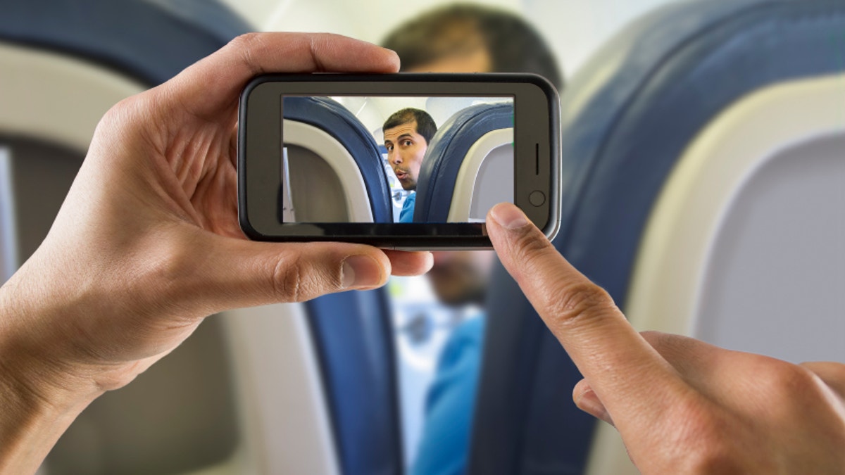 1da74be2-photographing a surprised man on a plane