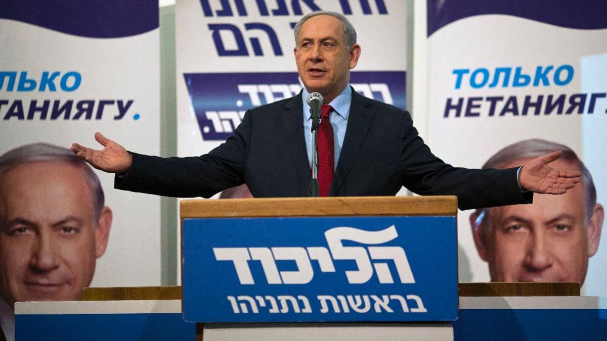Israeli Prime Minister Benjamin Netanyahu speaks to his Likud party members during a campaign event near Tel Aviv, Israel, Monday, Feb. 9, 2015. Netanyahu on Monday accused the publisher of the Yediot Ahronot daily newspaper of carrying out a smear campaign against him in the hopes of pushing him out of office. (AP Photo/Ariel Schalit)