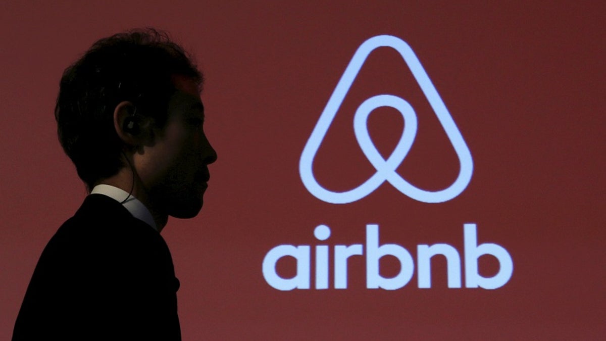 A man walks past a logo of Airbnb after a news conference in Tokyo, Japan, November 26, 2015. REUTERS/Yuya Shino/File Photo - RTX2RC1X