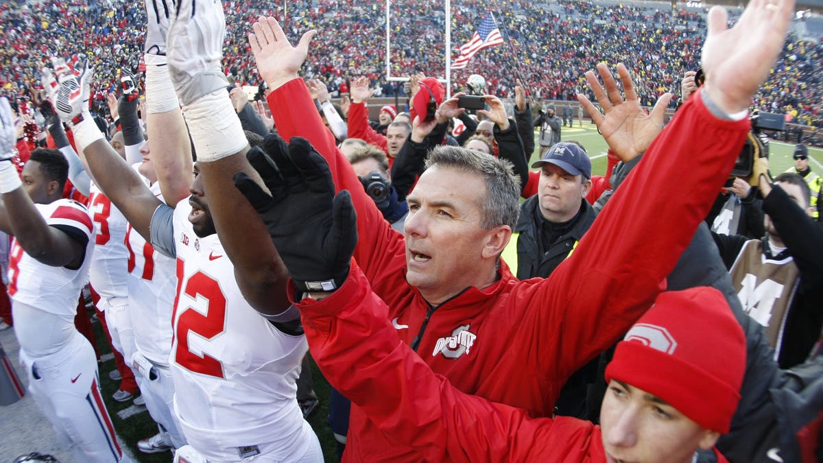 Ohio State head coach Urban Meyer joins his team in singing the school's alma mater after their 42-41 win over Michigan in an NCAA college football game Saturday, Nov. 30, 2013 at Michigan Stadium in Ann Arbor, Mich. (AP Photo/Detroit Free Press, Julian H. Gonzalez) DETROIT NEWS OUT; NO SALES, MANDATORY CREDIT