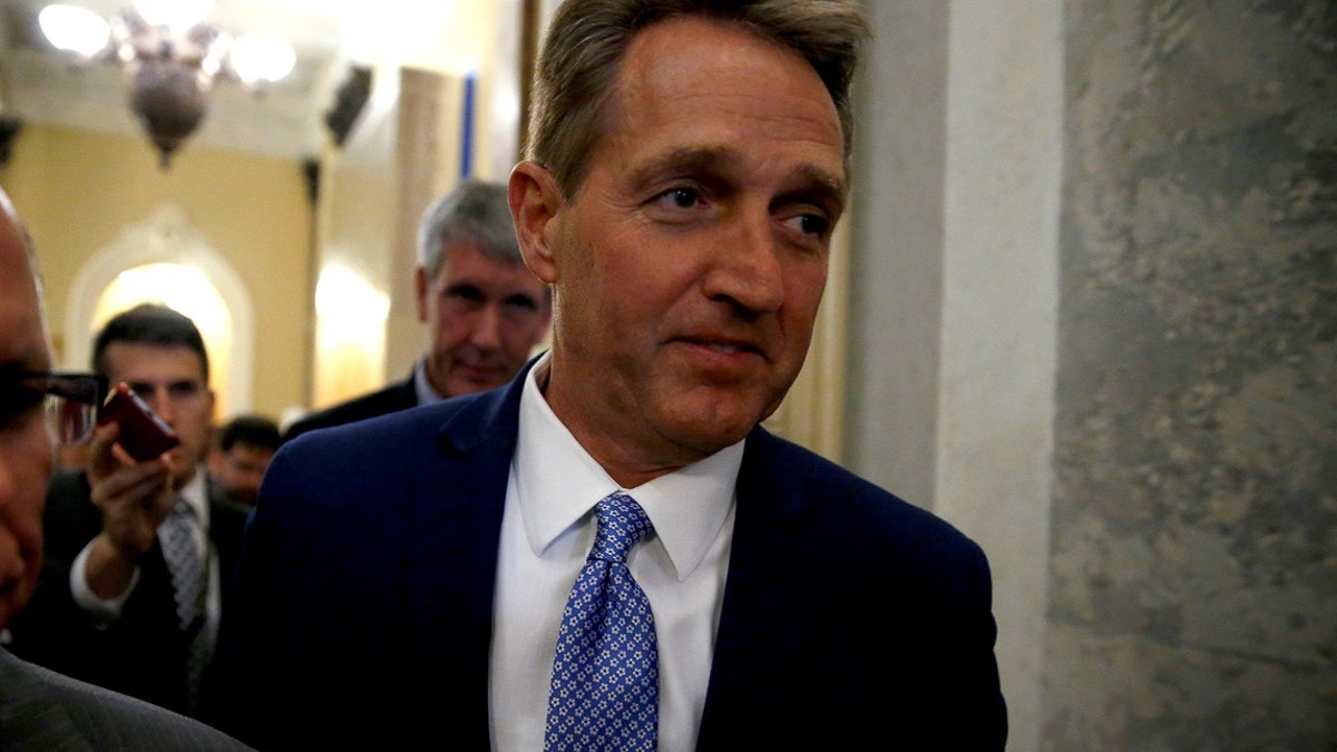 U.S. Senator Jeff Flake (R-AZ) walks past journalists after announcing he will not run for reelection on Capitol Hill in Washington, DC, U.S. October 24, 2017. REUTERS/Joshua Roberts - RC115CA83EE0