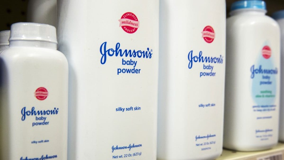 Bottles of Johnson & Johnson baby powder line a drugstore shelf in New York
