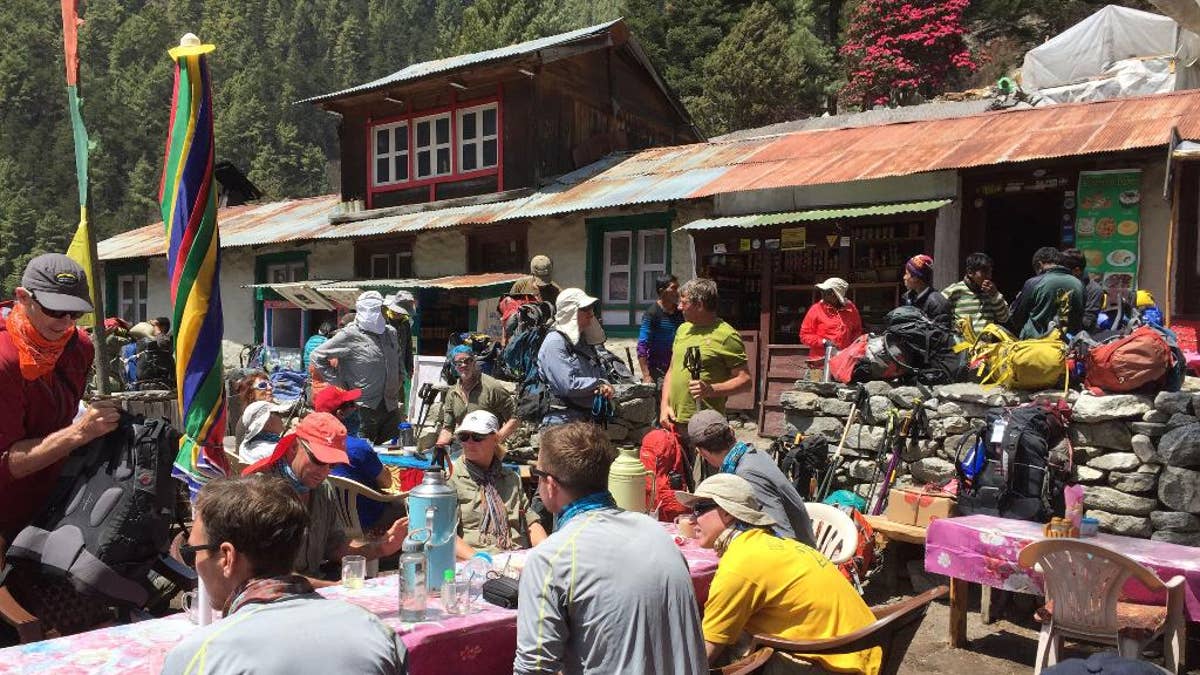 This April 6, 2016 photo shows trekkers at a rest stop north of the village of Namche Bazaar, Nepal. April falls into the peak season for trekking and the trail is often crowded. A trek to Everest Base Camp along mountain paths that hug deep gorges offers renewal and a test of mental and physical limits. Along the way there are sore knees and altitude sickness, but the spectacular landscapes, friendly villagers and moments of tranquility make the journey an unforgettable experience. (AP Photo/Karin Laub)