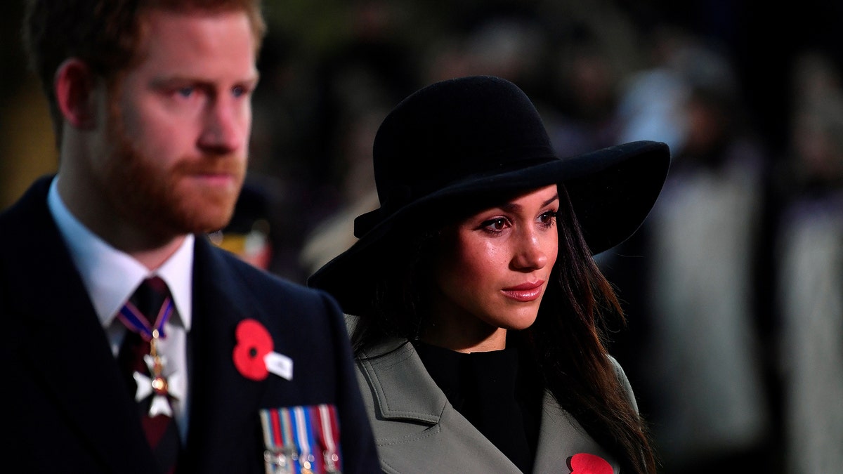 Britain's Prince Harry and his fiancee Meghan Markle attend the Dawn Service at Wellington Arch to commemorate Anzac Day in London, Britain, April 25, 2018. REUTERS/Toby Melville/Pool - RC13432AB280