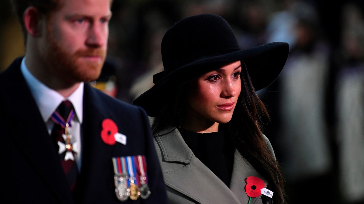 Britain's Prince Harry and his fiancee Meghan Markle attend the Dawn Service at Wellington Arch to commemorate Anzac Day in London, Britain, April 25, 2018. REUTERS/Toby Melville/Pool - RC13432AB280